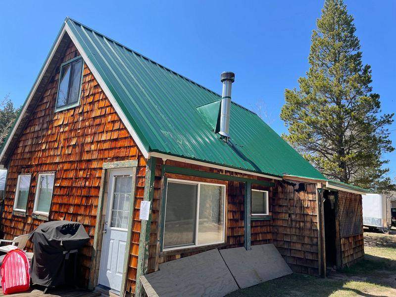 Green metal roof on a cedar-shake A-frame cabin in the Lake Tahoe area