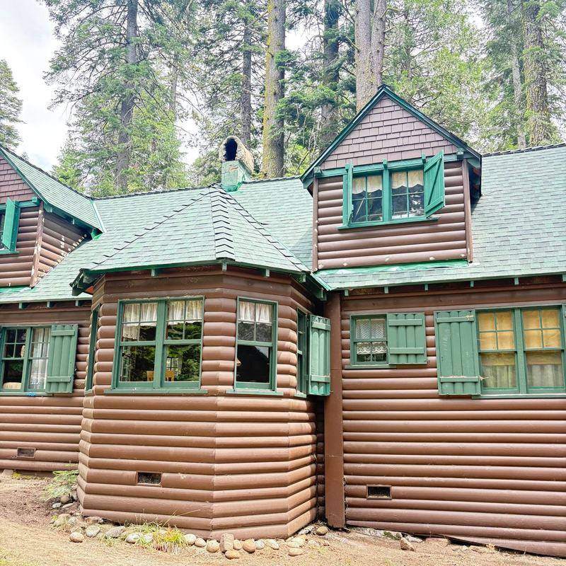 Log home with a green metal roof and green shutters in the Lake Tahoe area